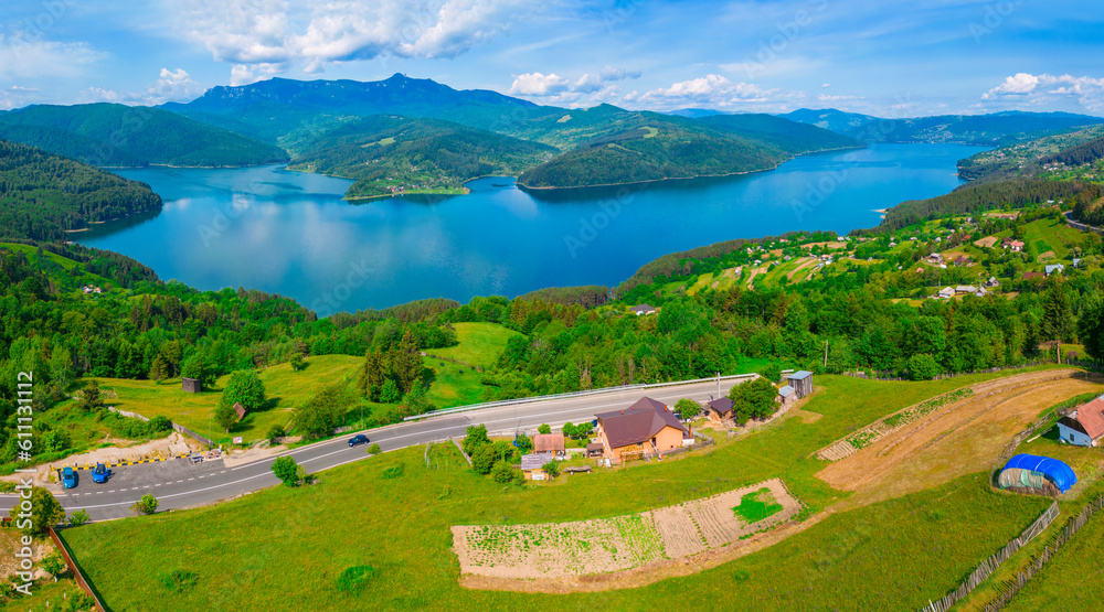 Panorama of Bicaz lake and Ceahlau mountain in Romania, summer landscape
