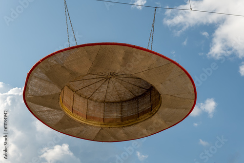 large decorative straw hat with a view of the sky