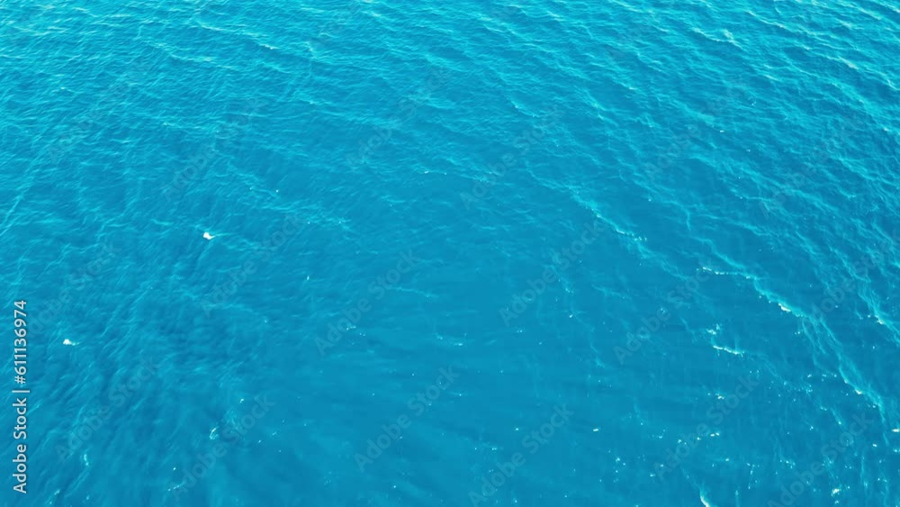 Aerial top down view of sea surface turquoise water, moving forward