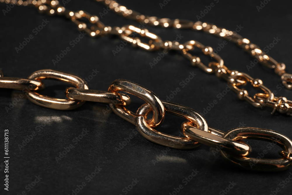 Fototapeta premium Beautiful chain bracelets on black background