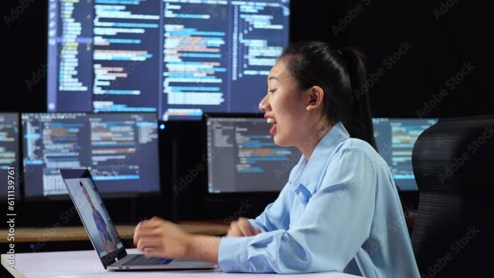 Side View Of Asian Female Programmer Having A Meeting By A Laptop While Writing Code On Multiple Monitors Showing Database On Terminal Window Desktops In The Office
Side View Of Asian Female Programmer Having A Meeting By A Laptop While Writing Code On Multiple Monitors Showing Database On Terminal Window Desktops In The Office