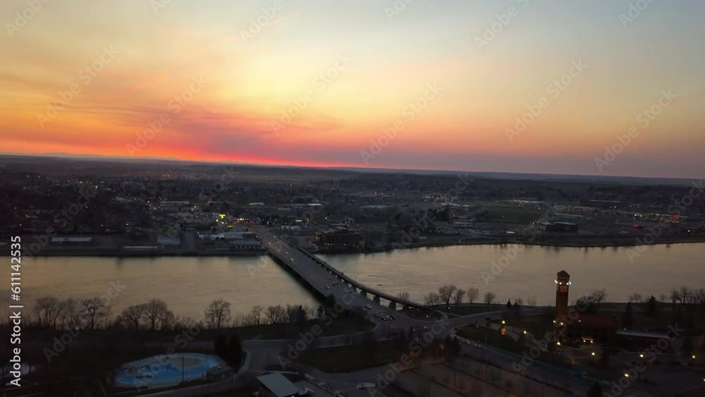Aerial Backward Shot Of Vehicles Moving On Bridge Over River Against Sky In City At Sunset - Billings, Montana Aerial Backward Shot Of Vehicles Moving On Bridge Over River Against Sky In City At Sunset - Billings, Montana
