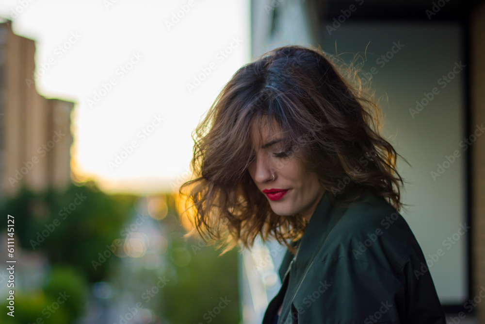 Beautiful girl on a balcony at sunset Beautiful girl on a balcony at sunset