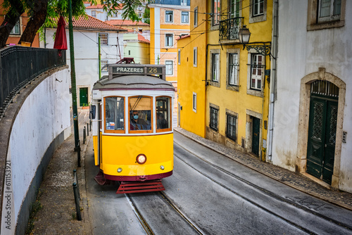 Famous vintage yellow tram 28 in the narrow streets of Alfama district in Lisbon  Portugal - symbol of Lisbon  famous popular travel destination and tourist attraction