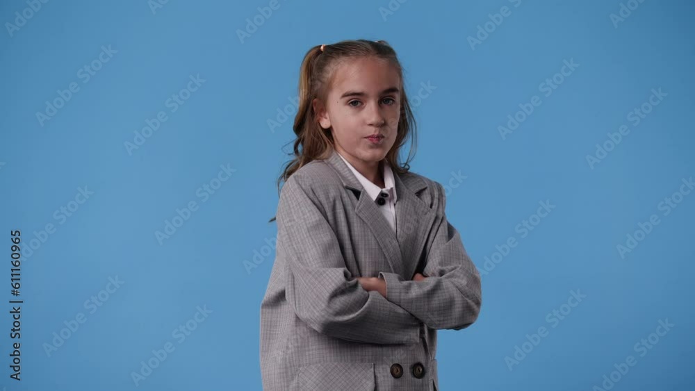 4k video of one girl who crosses her arms and posing over blue background. 4k video of one girl who crosses her arms and posing over blue background.