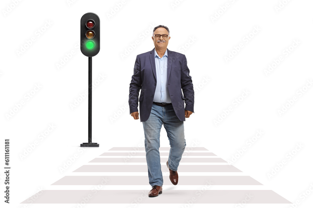 Φωτογραφία Full length portrait of a mature man in jeans and suit walking across a street a