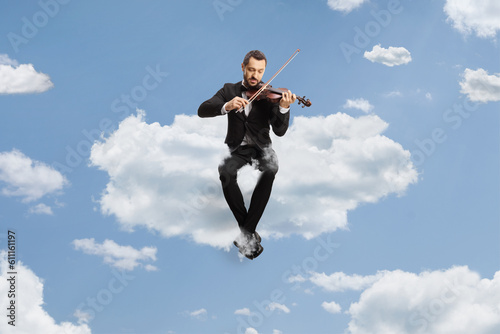 Violinist sitting on a cloud and playing a violin