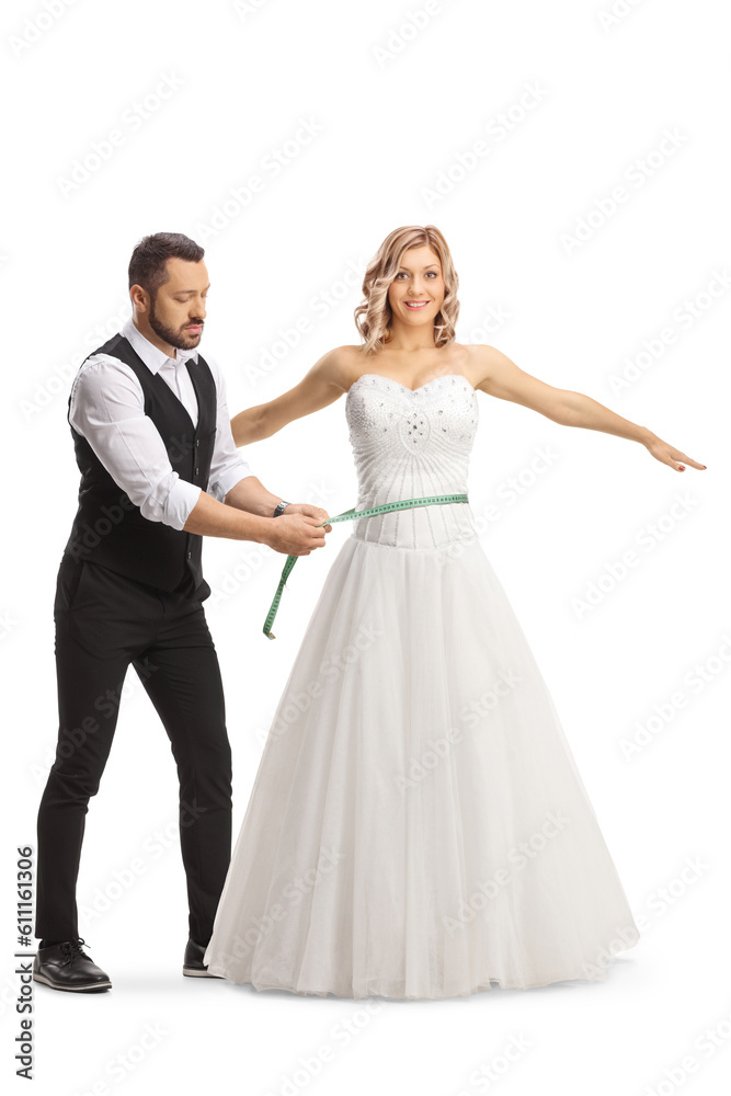 Tailor taking measures for a bridal dress