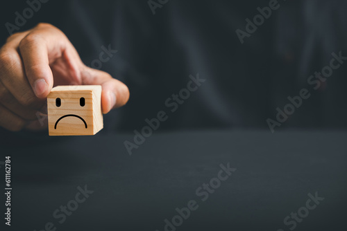 Unsatisfied customer expressing dissatisfaction on a wooden block. Concept of bad product quality, low rating, and negative comment. The impact of unsatisfied customers on business reputation.