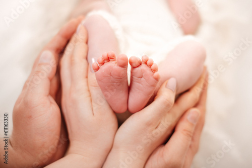 baby feet in hands © Alena Vilgelm