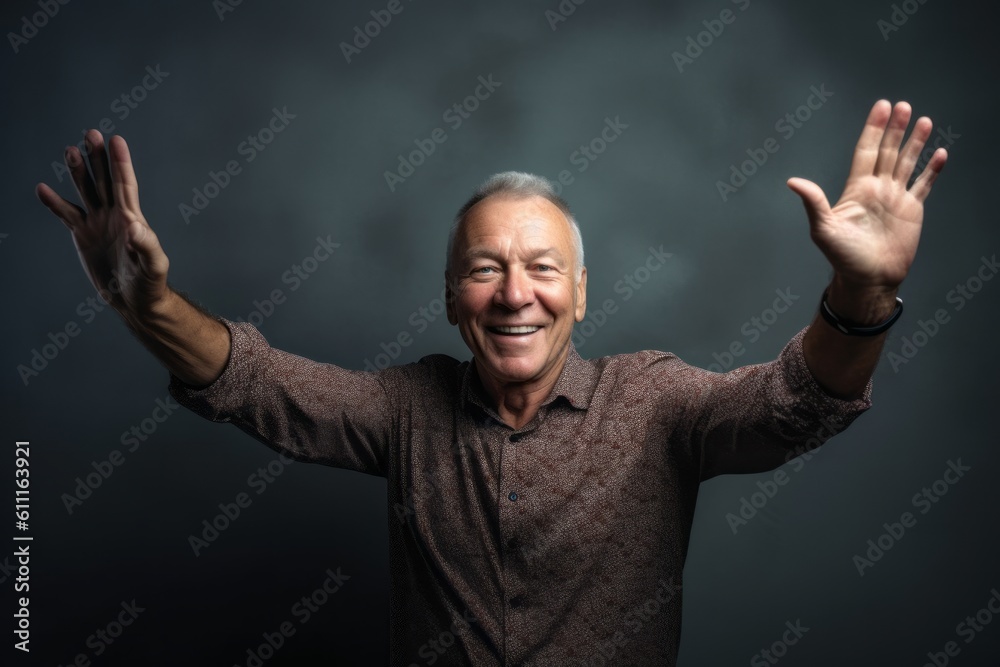 Medium shot portrait photography of a glad mature man extending arms to one side in a gesture of freedom against a metallic silver background. With generative AI technology