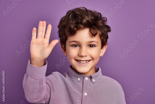 Lifestyle portrait photography of a happy kid male waving with the hand against a lilac purple background. With generative AI technology