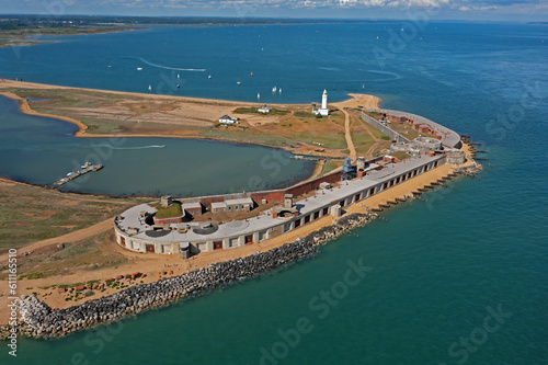 Hurst Point lighthouse and Castle on the waters edge on the South Coast in England. Beautiful aerial view on the land surrounded by water, with space for text. photo