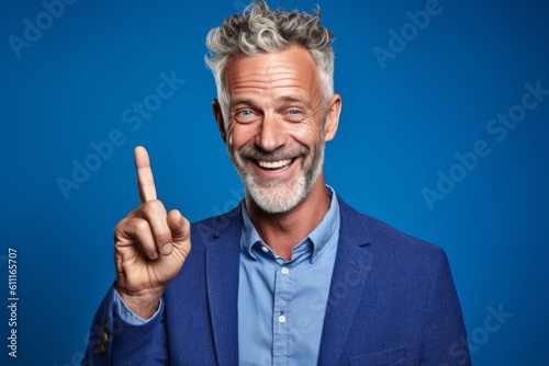Headshot portrait photography of a happy mature man making a i have an idea gesture with a finger up against a periwinkle blue background. With generative AI technology