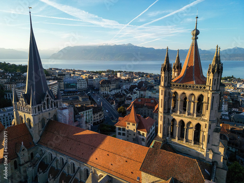 Wallpaper Mural Lausanne, Switzerland, August 22nd 2022. An aerial drone shot of Lausanne cathedral, the city centre, and Lake Geneva at sunrise. Torontodigital.ca