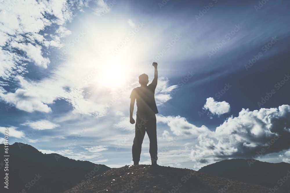 Man rise hand up to amazing blue sky feel never give up and freedom.