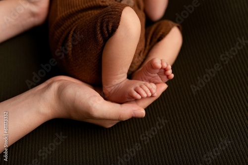 newborn photography details: newborn tiny feet in mother’s hands