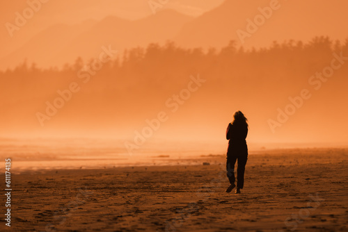 Tableau sur toile A woman walks alone at Long Beach in the Pacific Rim National Park Reserve on th