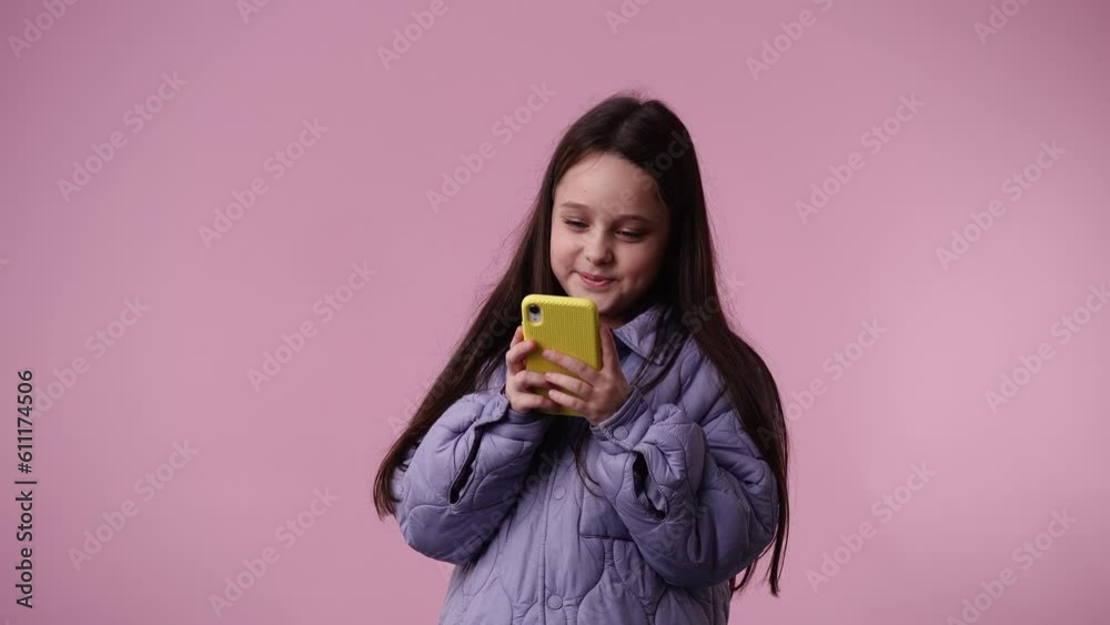 4k video of one child typing text laughingly over pink background. 4k video of one child typing text laughingly over pink background.