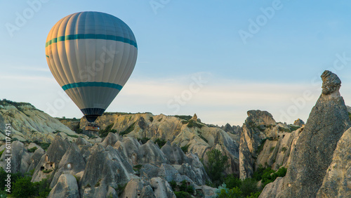 Cappadocia Turkey. Hot air balloons flying over fairy chimneys at sunrise in Cappadocia. Travel to Turkey. Touristic landmarks of Turkiye. Selective focus included.