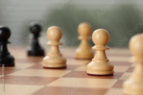 Wooden pawns on chess board  closeup. Space for text