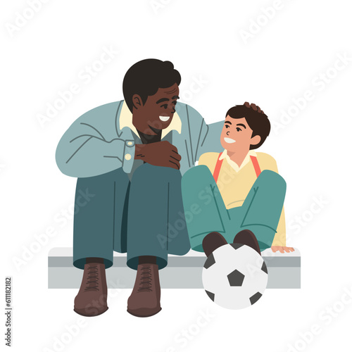 A black older man and a young boy are talking while holding a ball
