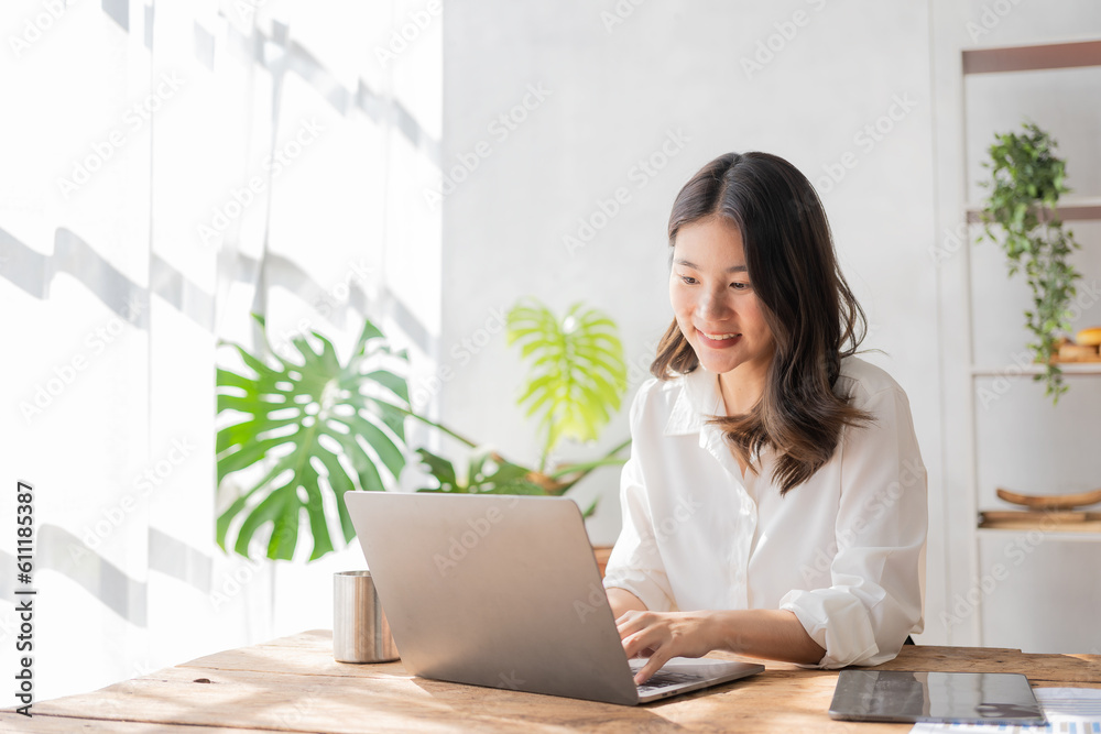 Asian businesswoman sitting at desk with laptop and tablet calculating financial graph showing results about investment growing successful business Asian businesswoman sitting at desk with laptop and tablet calculating financial graph showing results about investment growing successful business