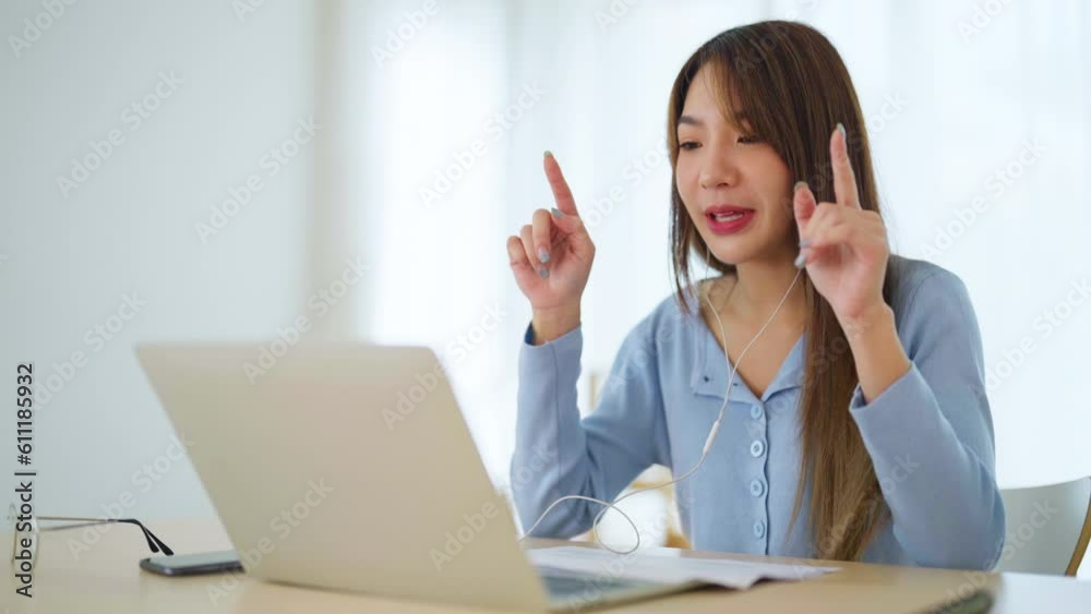 Young asian woman working at home. Female using computer laptop on desk at house Young asian woman working at home. Female using computer laptop on desk at house