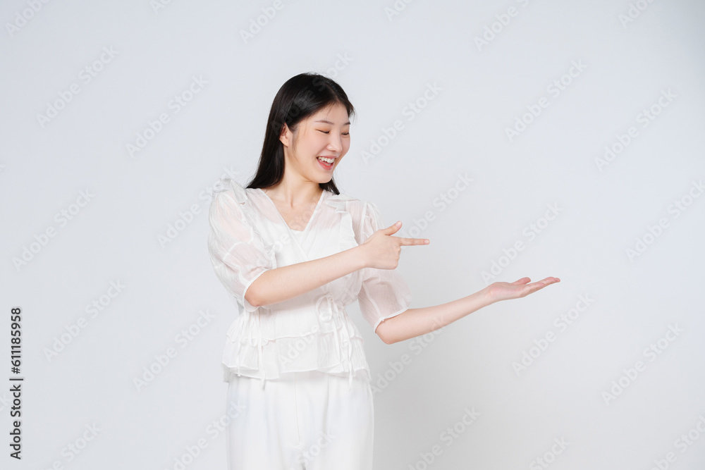 Happy young woman presenting or showing open hand palm with copy space for product isolated on white background. Happy young woman presenting or showing open hand palm with copy space for product isolated on white background.