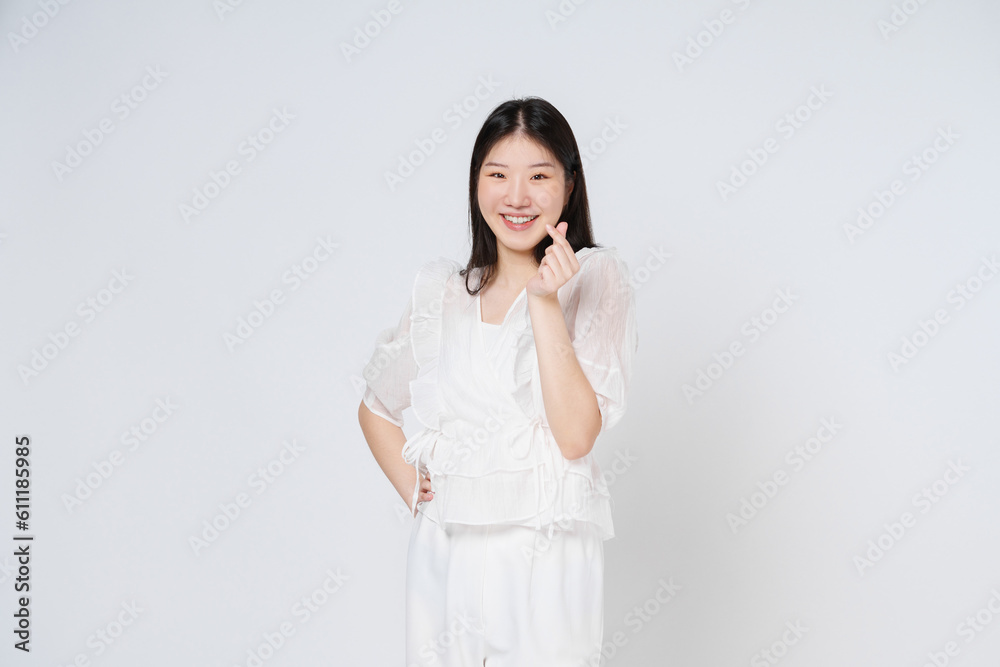Young woman showing mini heart sign isolated over white background. Young woman showing mini heart sign isolated over white background.