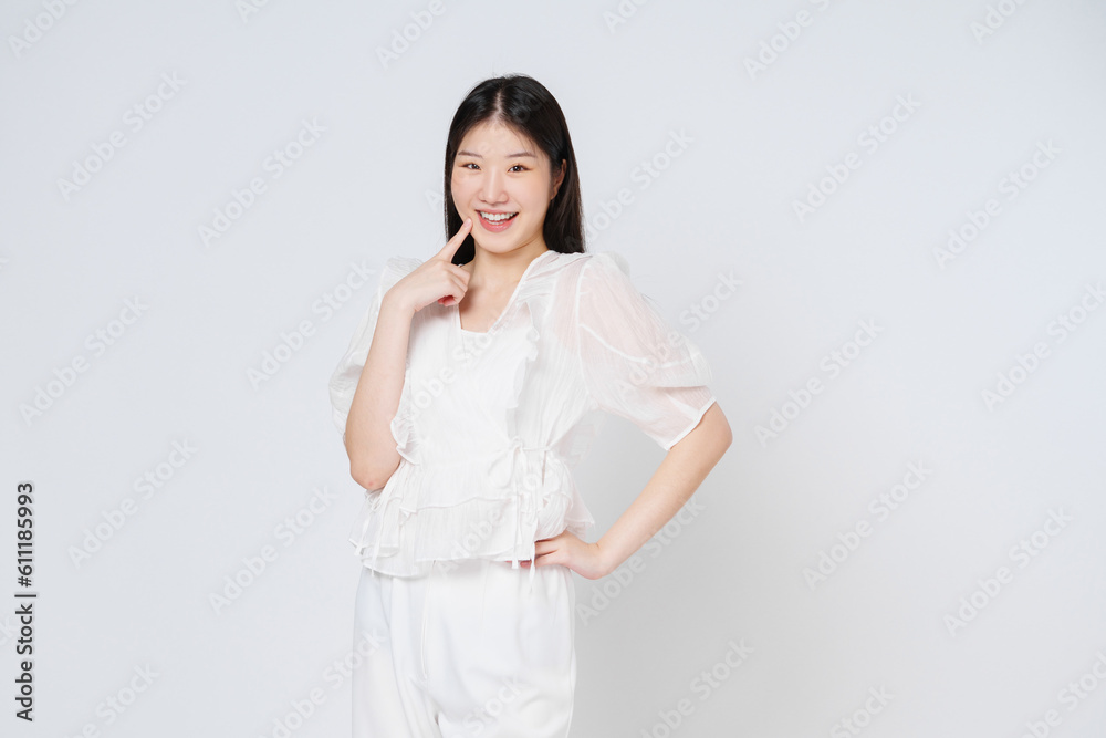 Young woman has nice smile and get satisfied something, look at camera isolated on white background. Young woman has nice smile and get satisfied something, look at camera isolated on white background.