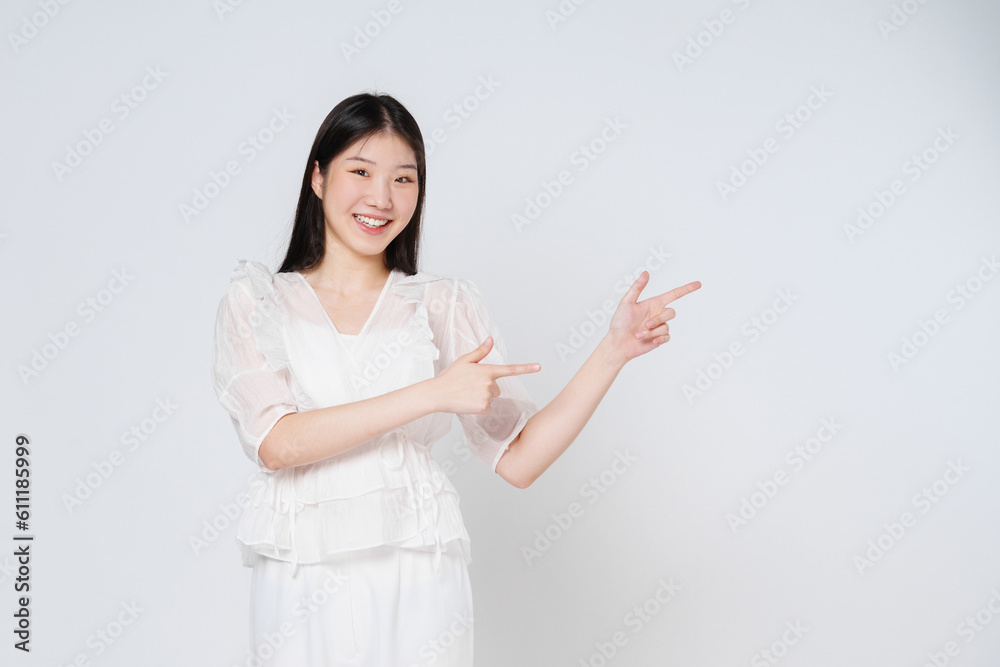 Young woman pointing to empty copy space isolated on white background. Young woman pointing to empty copy space isolated on white background.