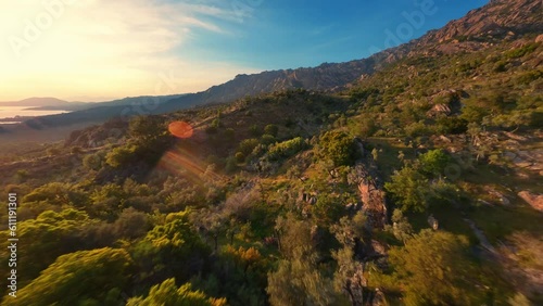 FPV drone flying over beautiful mountains at sunset. 
Lake Bafa surroundings. Turkey.
Smooth flight close to branches photo