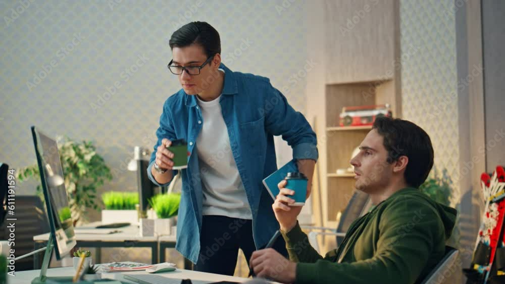 Creative freelancers pointing monitor at office. Inspired businessman gesturing Creative freelancers pointing monitor at office. Inspired businessman gesturing