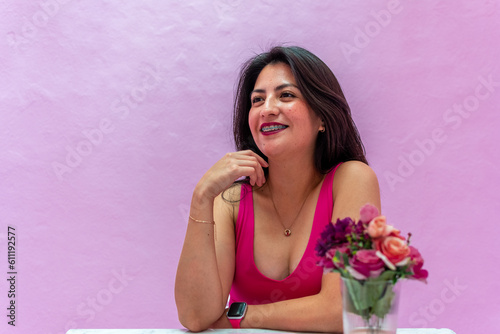 girl dressed in pink blouse for photos on purple background