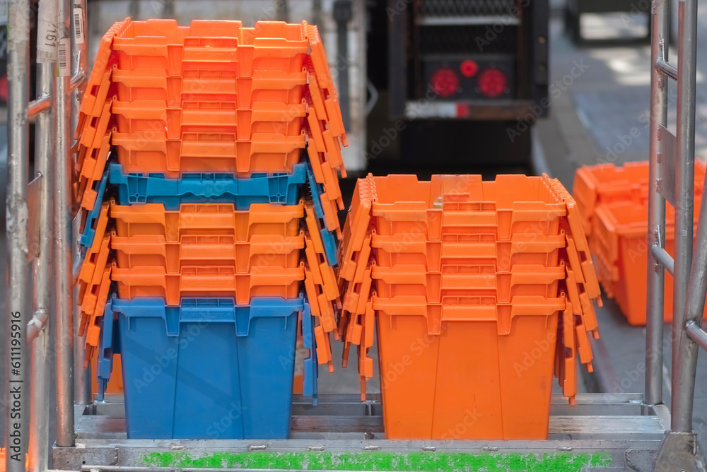 Rows of orange and blue plastic bins Rows of orange and blue plastic bins