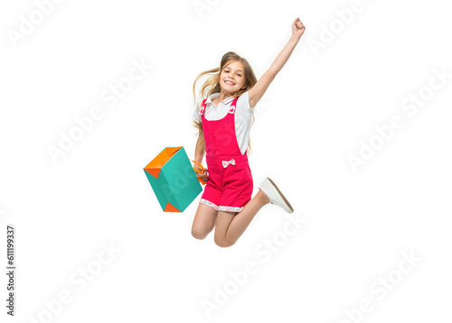 cheerful teen girl jumping after shopping on background. photo of teen girl jumping