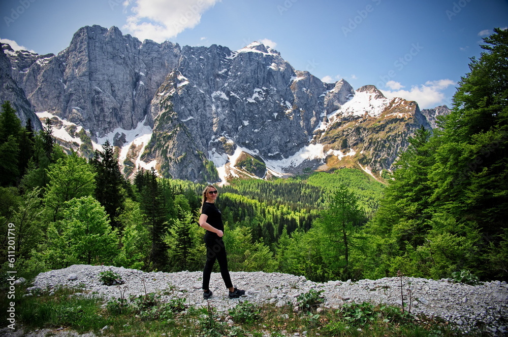 Mature woman standing at the edge of a cliff in Italian Alps