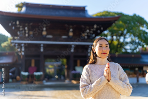 Принти на полотні Young Asian woman praying in traditional Meiji Jingu Shrine in Tokyo city, Japan