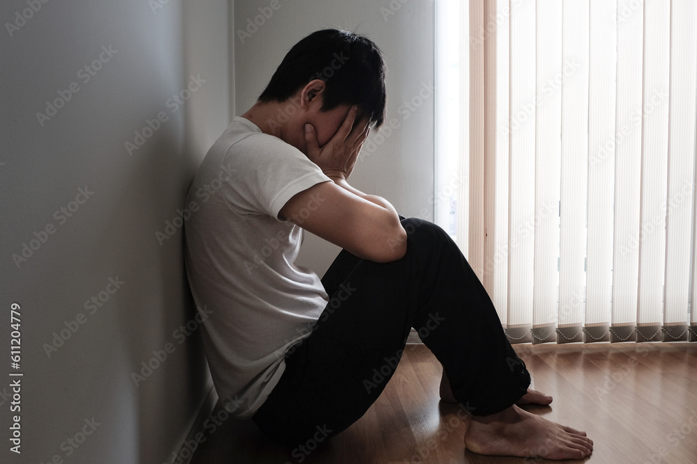 the man sitting in the corner of the room has emotional and mental problems He has depression and stress from society and work. medical concept. the man sitting in the corner of the room has emotional and mental problems He has depression and stress from society and work. medical concept.