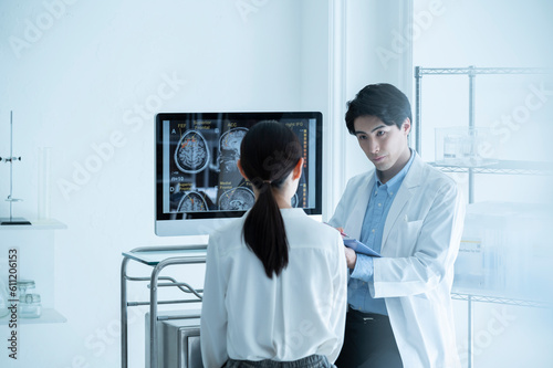 Surgeon talking to patient in examination room photo