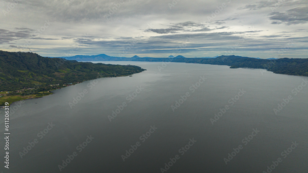 Aerial drone of Lake Toba and the coast of Samosir Island. Tropical landscape. Sumatra, Indonesia. Aerial drone of Lake Toba and the coast of Samosir Island. Tropical landscape. Sumatra, Indonesia.