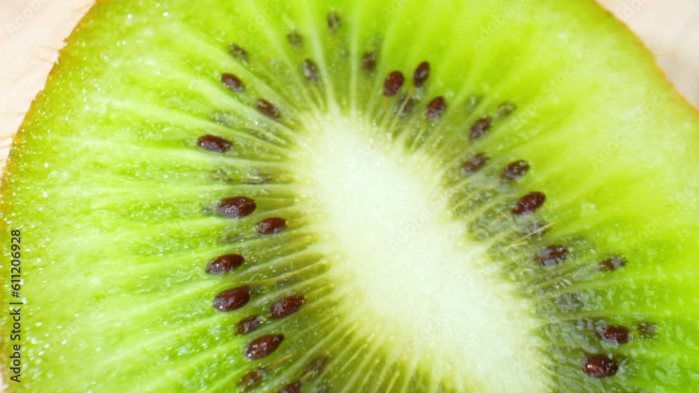 Delving into the macro world of a kiwi fruit, the video unveils a mesmerizing sight of a velvety emerald green flesh, sprinkled with a myriad of small, edible black seeds. Fruit and vegetable concept
Delving into the macro world of a kiwi fruit, the video unveils a mesmerizing sight of a velvety emerald green flesh, sprinkled with a myriad of small, edible black seeds. Fruit and vegetable concept
