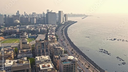 Aerial view of Marine Drive at Mumbai India. Girgaon Chowpatty Seaface aerial drone view, Local train speeding along the tracks as it travels through the bustling cityscape of Mumbai. photo