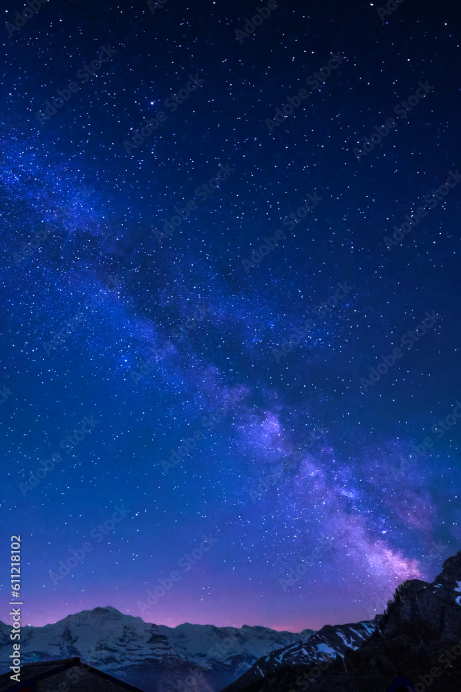 Obraz premium Milky Way and stars in night sky over the Swiss Alps at Lauterbrunnen with Eiger, Monch and Jungfrau peaks