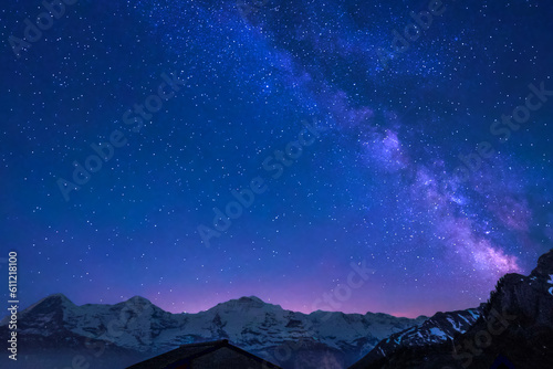 Milky Way and stars in night sky over the Swiss Alps at Lauterbrunnen with Eiger, Monch and Jungfrau peaks