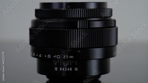 Closeup pan shot of the Jupiter 9 85mm f2.0 vintage retro lens. This famous portrait glas was produced in the soviet union by KMZ copying the Carl Zeiss Sonnar. It is multicoated and has a m42 mount. photo