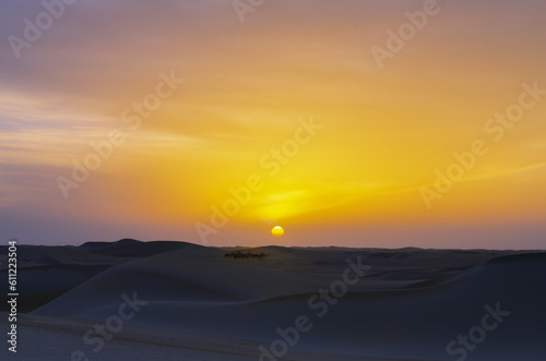 Sunset sunrise with beautiful cloud color in the desert sand dune. © Piak