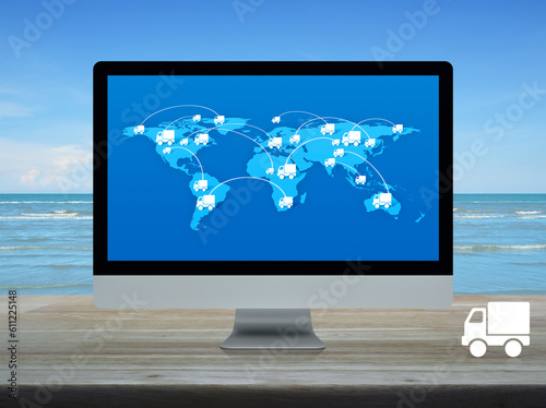 Delivery truck icon with connection line and world map on computer screen on table over tropical sea and blue sky, Business transportation online concept, Elements of this image furnished by NASA