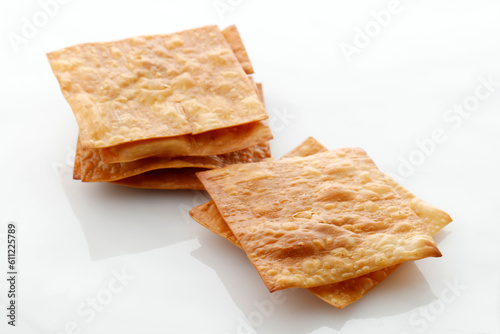 Deep Fried WOnton Sheet Isolated on White Background, Asian Popular Side Dish for Noodle or Wonton Soup